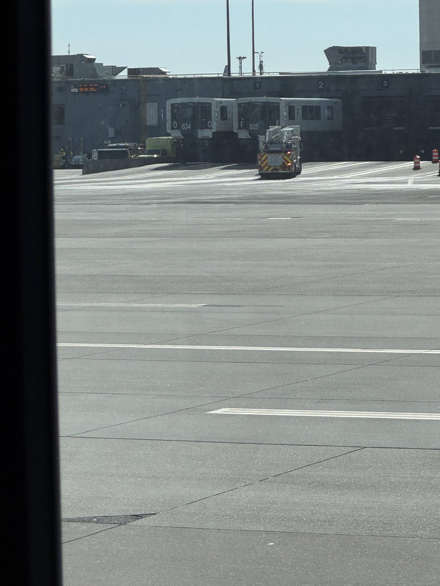 chrishassett's tweet photo. Sitting on the tarmac in the people mover at @Dulles_Airport getting brake checked while they figure out where to put us. Fire just pulled up to the D gate dock. https://t.co/RcMMKGr1f4