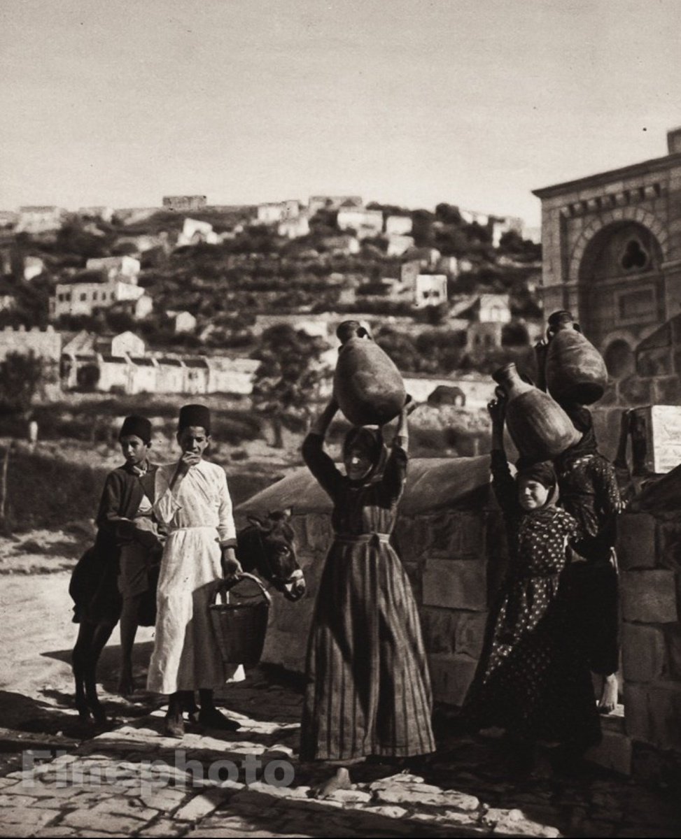 Palestinian women carrying water fetched from Mary's well in Nazareth, historic Palestine in 1925.