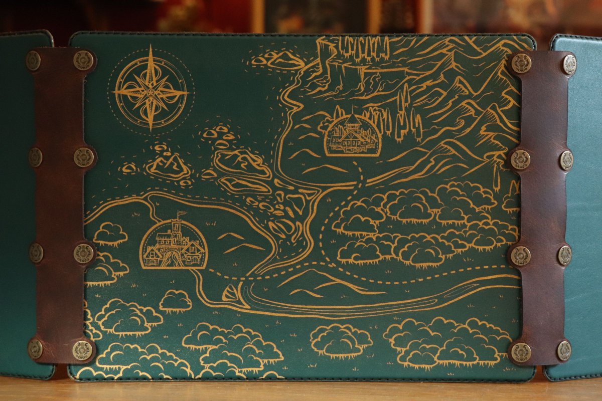 SpeechlessBard's tweet photo. We see new orders pop in for gold inlay on green leather, like this DM screen with one of our three Map panels 🗺️ 
It's a good thing we picked up some extra green recently! It's trickier to find a nice pine leather than you think 🌲 
#ttrpg #dmscreen #leather https://t.co/LslE2lkwKT