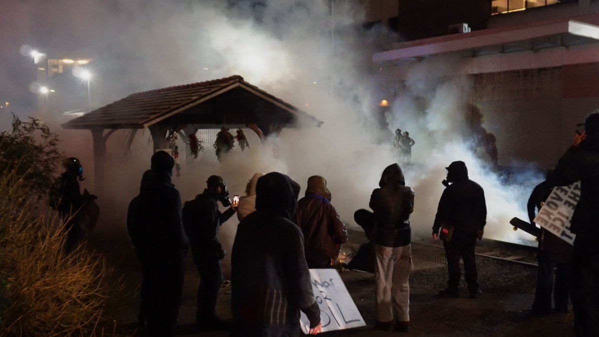 ICE officers fired multiple rounds of tear gas at protesters Saturday night.  I grabbed this shot of the trolley station and memorial being gassed.  One canister landed right in the middle of the memorial.