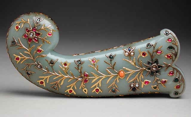 Jade dagger hilt with rubies, emeralds, pearls, coral, spinels, sapphires, and glass set in gold. India, Mughal Empire, 1850.