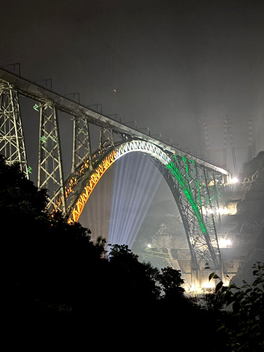 The mighty Chenab Bridge, the world’s highest Railway arch bridge, stands resplendent, bathed in radiant Tricolour lights, echoing the spirit of the Nation on the eve of #RepublicDay2026 🇮🇳.