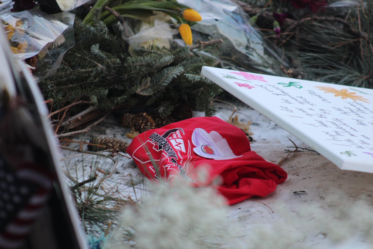 signs left at alex pretti’s memorial in minneapolis: “i love you so much / i’ll miss you forever” photo with a friend, “i would have done the same. RIP alex,” a stethoscope and “we’ll take it from here, alex” and a tshirt for the minnesota nurses association