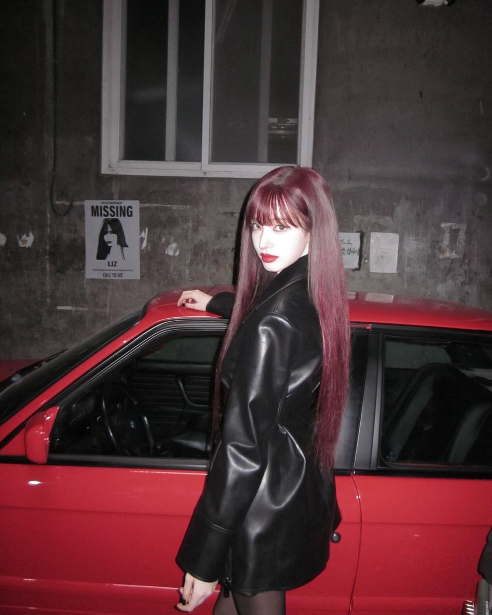 Lijzzie's tweet photo. under the hush of concrete walls and fading streetlight, she stands beside crimson metal like a scene paused in time. Leather draped with quiet confidence, dark lips holding untold stories, and eyes that refuse to look away. Somewhere between danger, she becomes the moment. https://t.co/KQKV1aMMV2