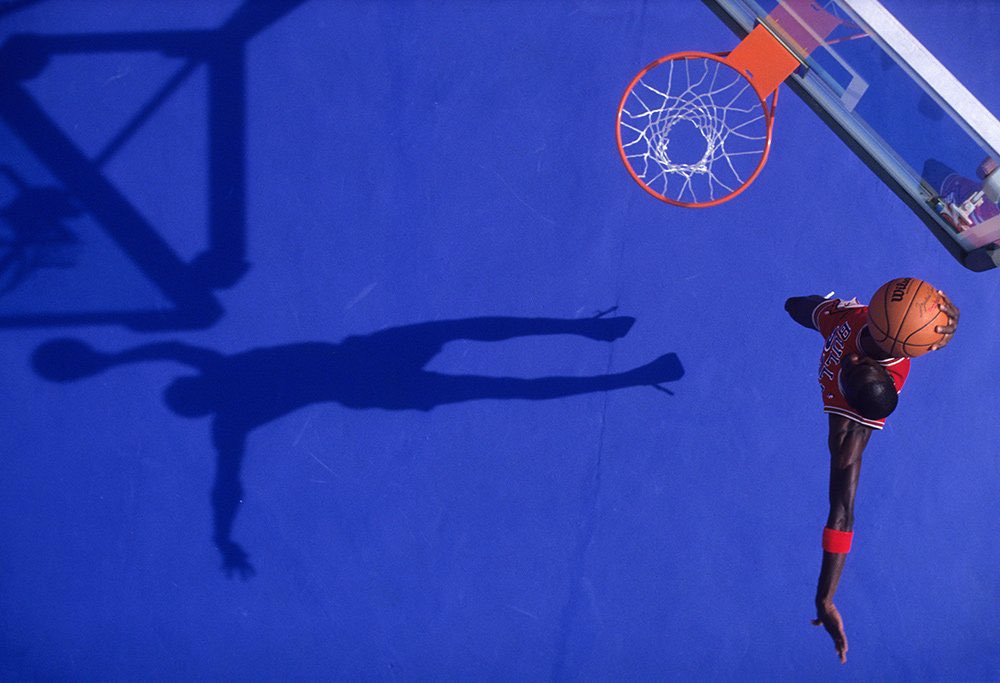 VintageHoops's tweet image. MJ dunks during a July 1987 SI photo shoot and that shadow is perfection.