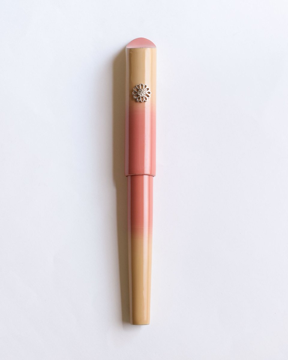 【再入荷】
輪島復興のシンボルとして制作された能登万年筆　朱鷺色ぼかしが待望の再入荷。
能登半島の特徴的なカタチを連想させる万年筆トップに、能登の空を舞うトキをイメージした色合い。
ローラーストッパーには純銀製の雪割草をあしらっています。

jp.wancherpen.com/collections/no…

#再入荷 #輪島塗