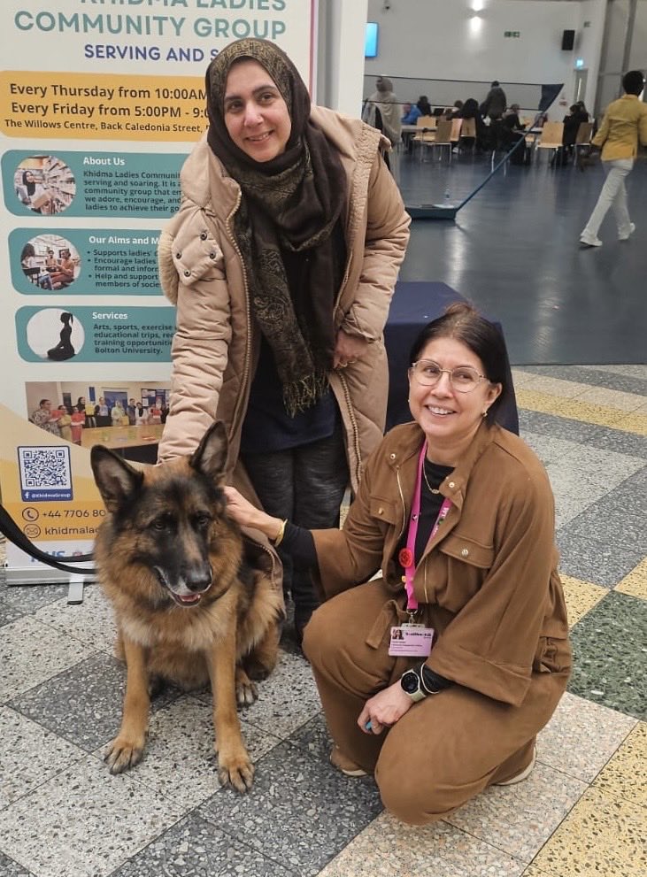 HWBolton's tweet photo. We had a good day at the health and wellbeing event in Bolton at the University of Greater Manchester today. Enjoyed meeting Bear the therapy dog who brings a ray of sunshine to residents in care homes. Lovely to see Tasneem from Khidma Ladies group too @KhidmaGroup https://t.co/yYgc99xwUg