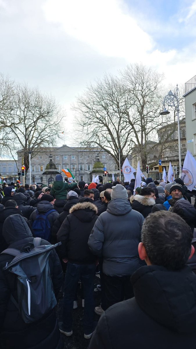 Mick_O_Keeffe's tweet photo. 🇮🇪🚨 BREAKING! 

A large crowd of migrant men who have been issued with deportation orders gathered outside Dáil Éireann today to demand blanket amnesty and an end to deportations. 

Do you remember what happened to that little girl at CityWest in October? That man had an outstanding deportation order. 

They're also promising "no justice, no peace." 

Sinn Féin and the Green Party have signed documents expressing support for these migrants and endorsing their position around amnesty. 

Irish people need to start taking this seriously, thousands of migrants are making demands of our country and promising "no peace" if their demands aren't met. 

At any other time in history this would be seen as an invading army.