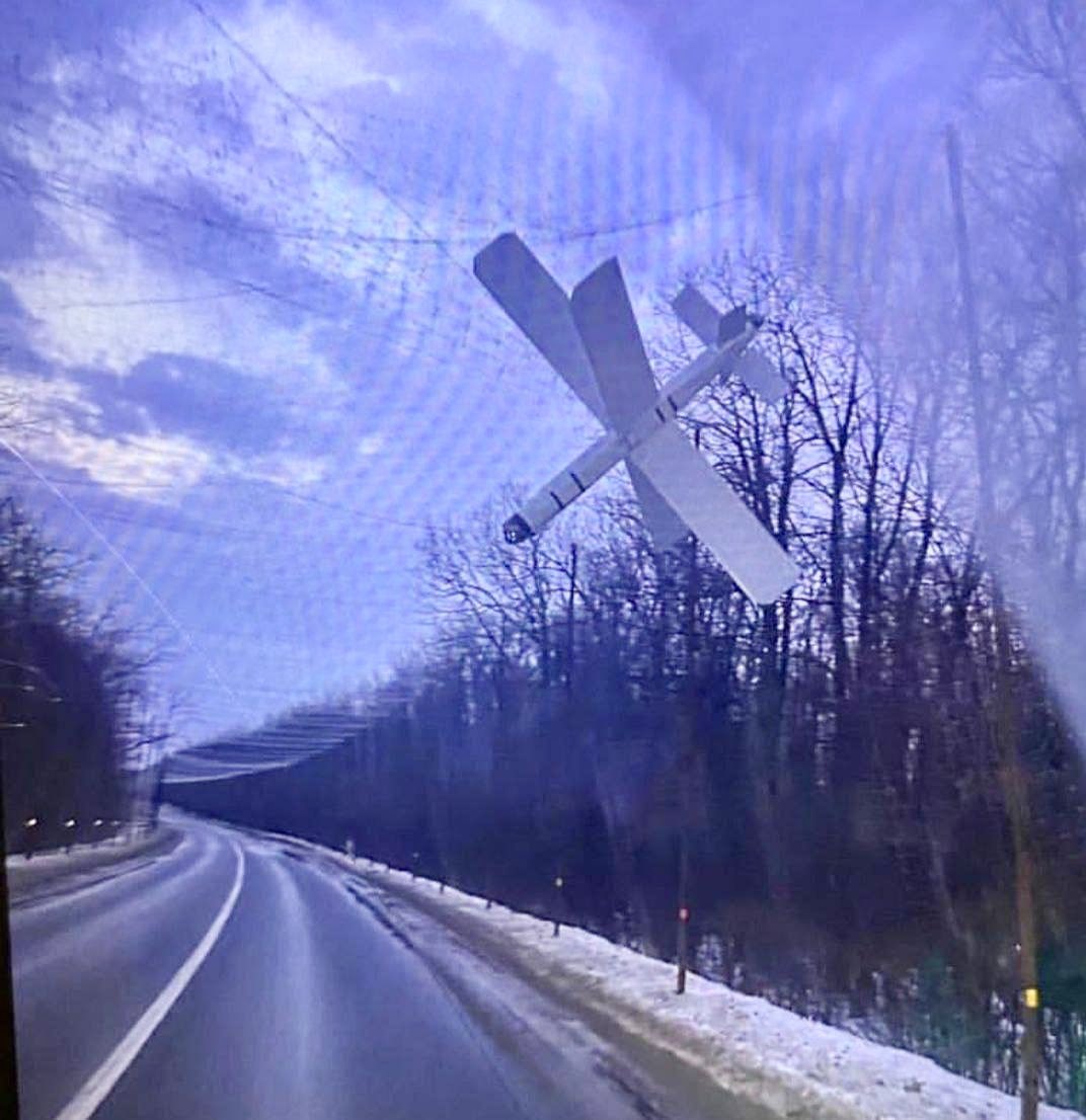 GrandpaRoy2's tweet photo. A big Russian "Lancet" strike UAV attacking a Ukrainian vehicle was stopped by the netting of a road net tunnel. https://t.co/XVyxLBbbdm