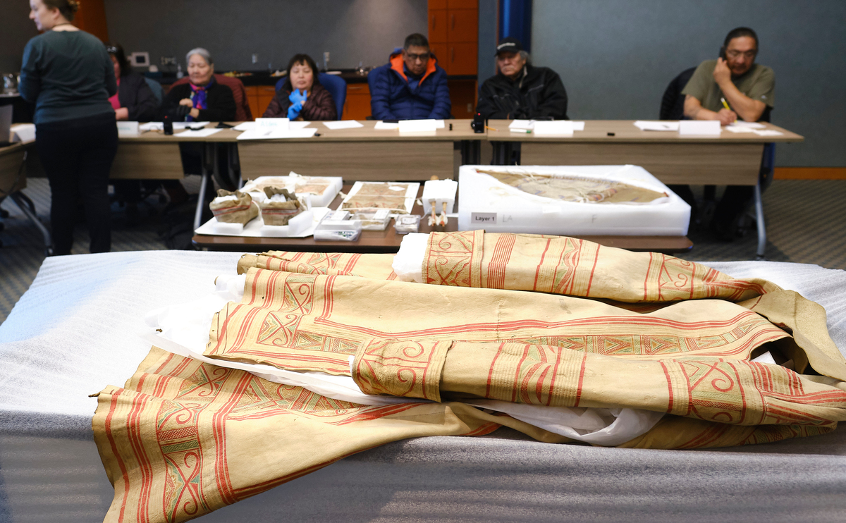 ntesinan's tweet photo. Traditional Innu caribou hunter’s coat estimated to be 200 years old unwrapped for elders during a workshop at The Rooms in St. John’s. Coat is made from caribou hide.  Innu elders say  decorations please Kanipinikuassikueu, the Caribou Master. #innunation https://t.co/lev5DVQjY2