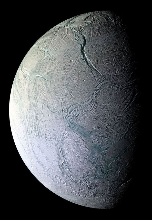Behold one of the most stunningly detailed views ever captured of Saturn's icy moon Enceladus—a frozen world that's secretly one of the solar system's most explosive little rebels.This razor-sharp Cassini spacecraft image reveals Enceladus up close, its dazzling white surface