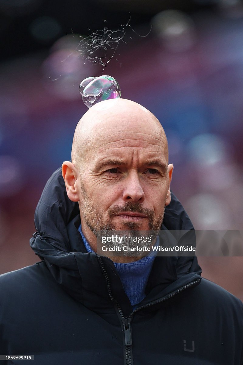 A bubble pops on the head of Manchester United manager Erik ten Hag during the Premier League match between West Ham United and Manchester United at London Stadium (2023)
