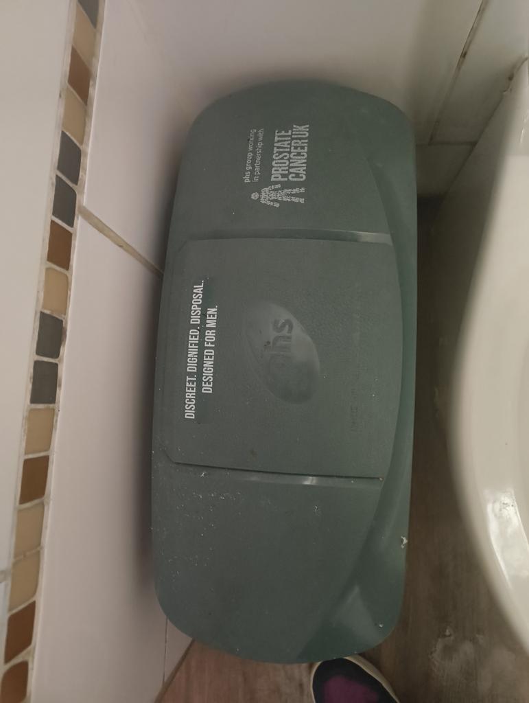 Saw this sanitary bin in the gents. After some discussion, we decided it might be to do with incontinence. 

I get that it's discreet, dignified disposal. But I have no idea in what way it's been "designed for men"
