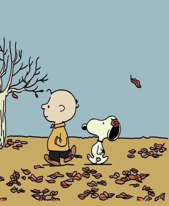 Charlie Brown and snoopy walking through leaves