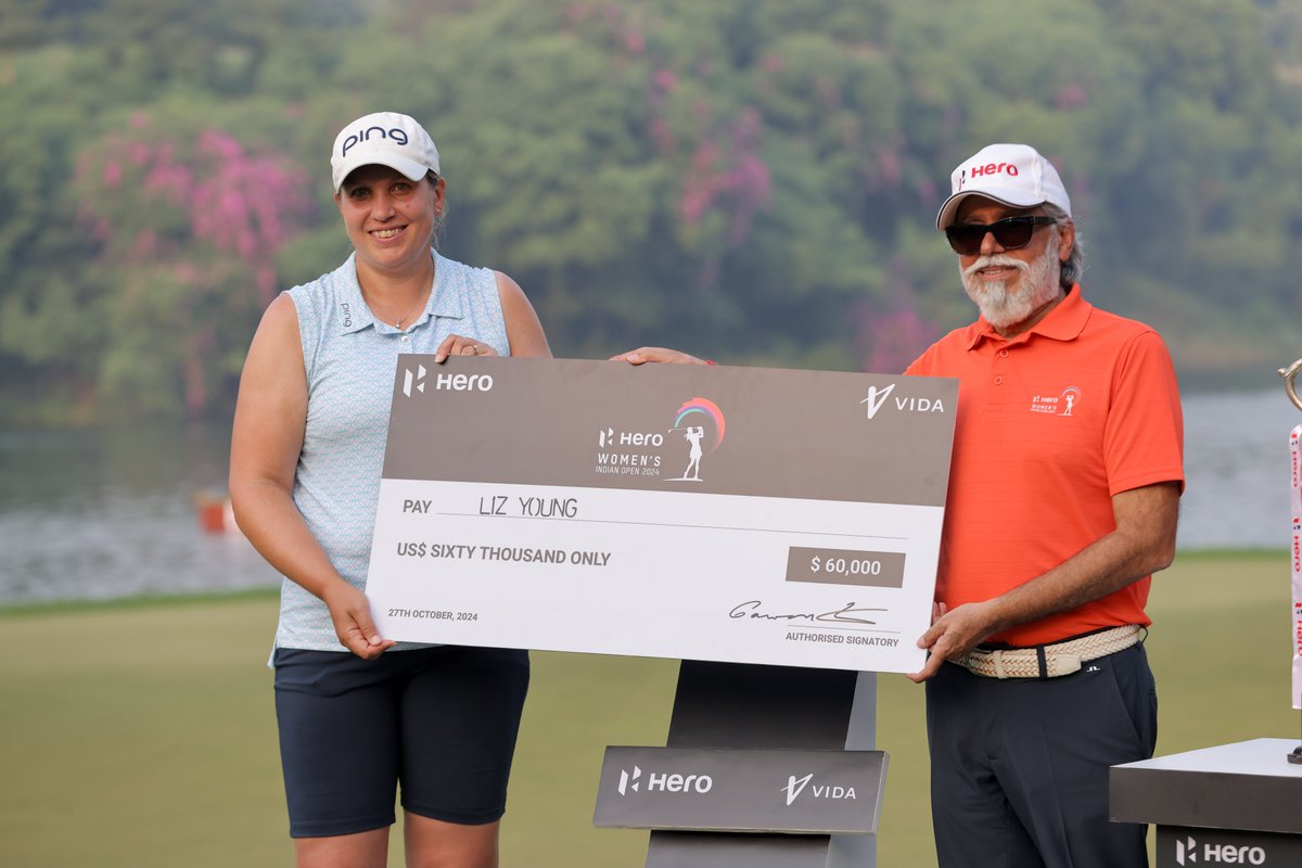 England's Liz Young is all smiles as she receives her Hero Women's  Indian Open Trophy and cheque for US$ 60,000  from Dr Pawan Munjal, Executive Chairman, Hero MotoCorp at the DLF Golf and Country Club.

#HeroWomensIndianOpen2024 #HWIO2024