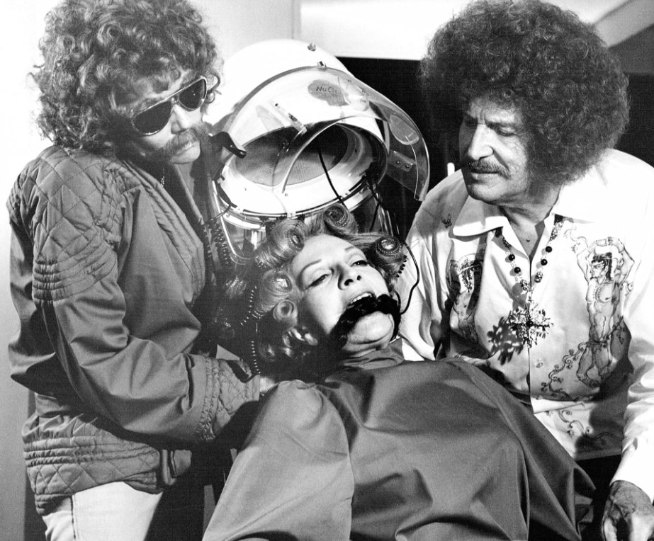 From 1974’s Theatre of Blood-a disguised Diana Rigg on the left gets to gag someone for a change. Vincent Price on the right-as a disgruntled actor offing critics via Shakespearian methods. Coral Browne as the damsel. Meeting for the first time, Vincent &amp; Coral wed in real life.