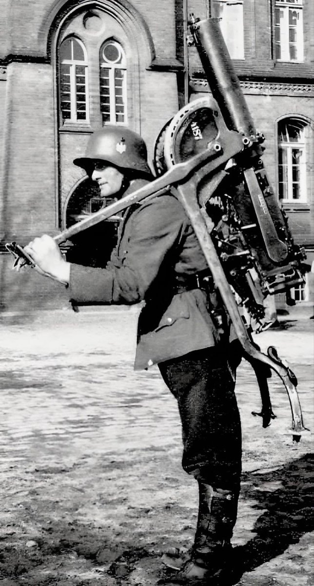 A German soldier carrying a Maschinengewehr 08 /MG 08 : German water cooled Heavy Machine Gun- HMG !