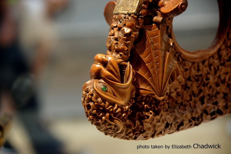 Close up of the dragon/beast head with emerald eye on the citole in the British Museum.   My photo.  Url here to the artefact itself. 
britishmuseum.org/collection/obj…