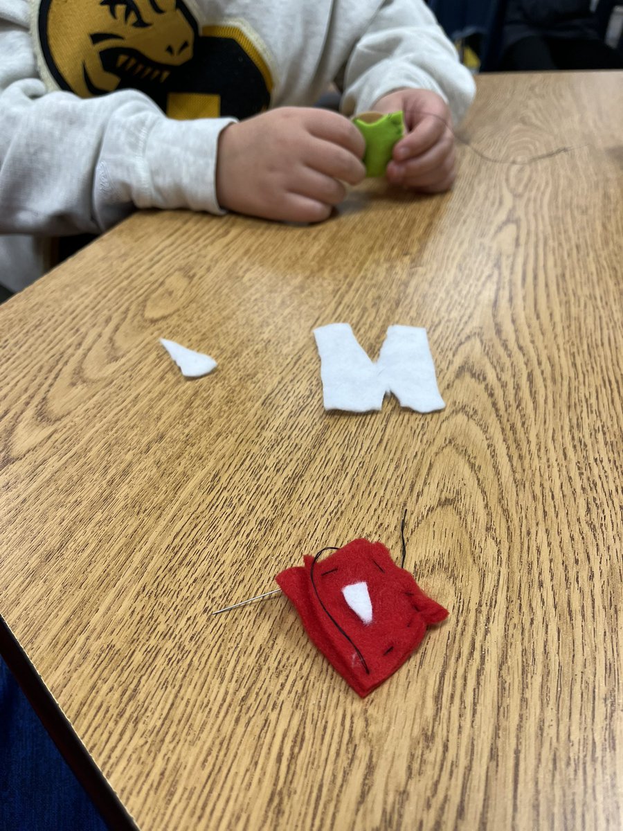 Special Projects Day 1! A student is teaching how to sew. We’re all making miniature pillows!