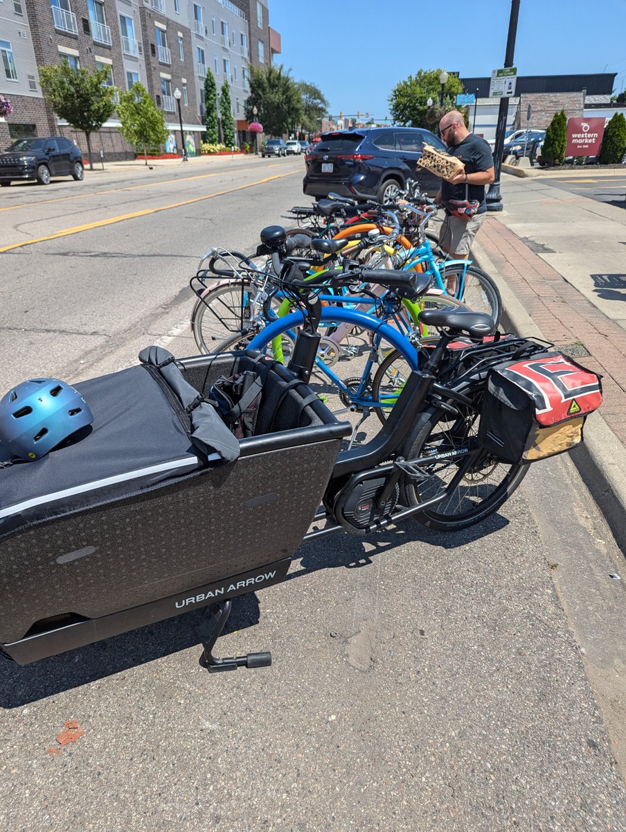 The full bike racks at this grocery store suggest that you can "grab groceries" without a car.