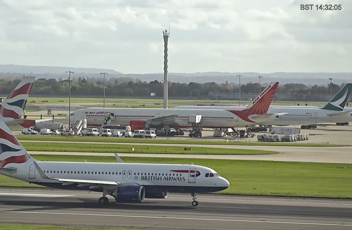 Siddhanth9636's tweet photo. Air India flight #AI129, operating a Boeing 777-300ER (VT-ALX) from BOM to LHR, parked at a remote stand with emergency services after receiving a bomb threat while on approach to London Heathrow. https://t.co/dRJtIGAVqa
