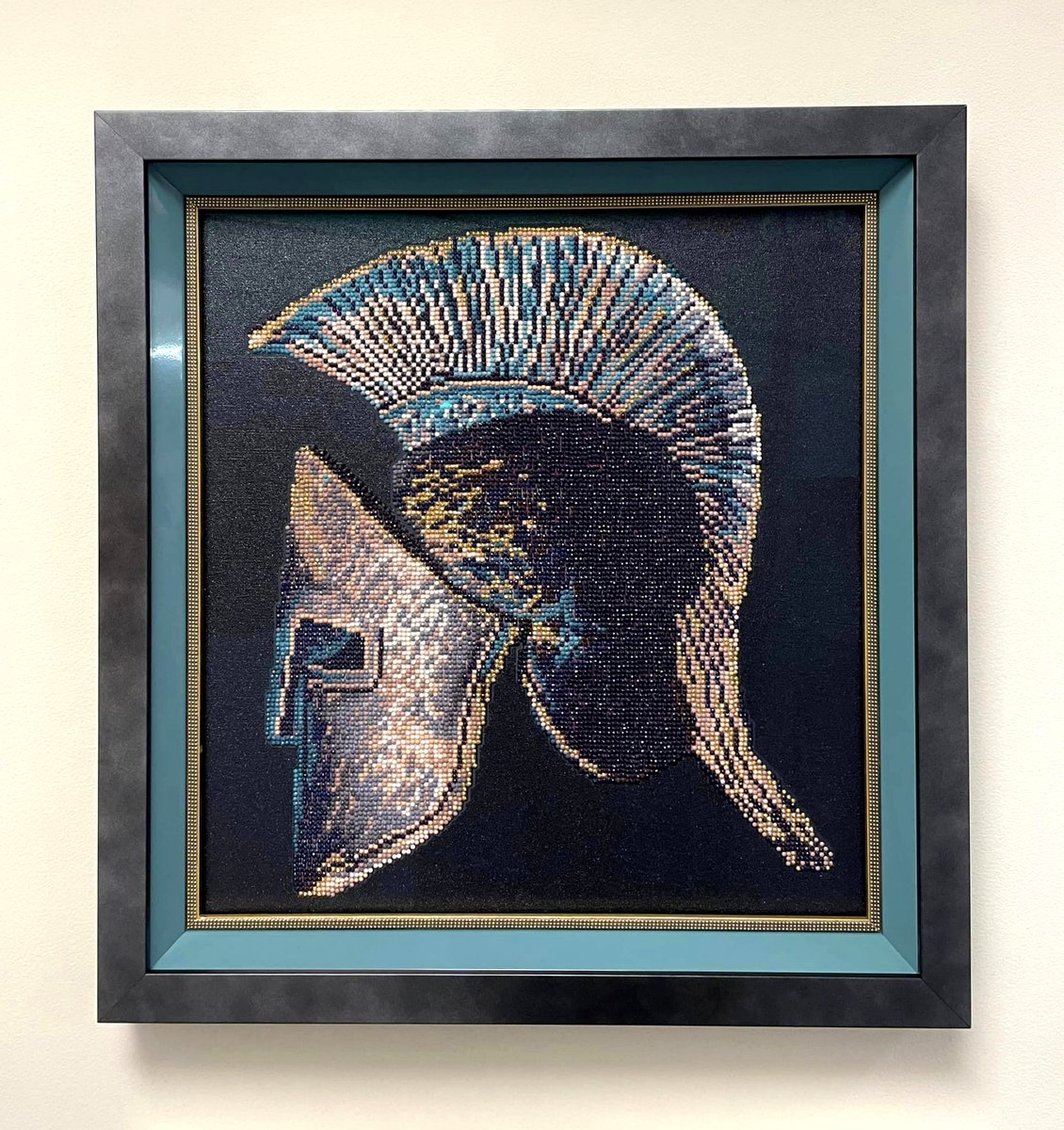 FramesUnlimited's tweet photo. Gem art but make it #Spartan, #FrameFridays! Our team crafted this #gem with a dark outer frame, a color-matched teal inner frame, a gold beaded fillet, and topped the piece with museum glass. #GemArt https://t.co/edpXTighXZ