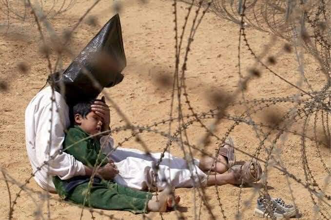 Gabbar0099's tweet photo. A detained Iraqi father comforts his 4 y/o frightened son at a US army base in Najaf, Iraq. 7/n https://t.co/yCj3gOg4O3