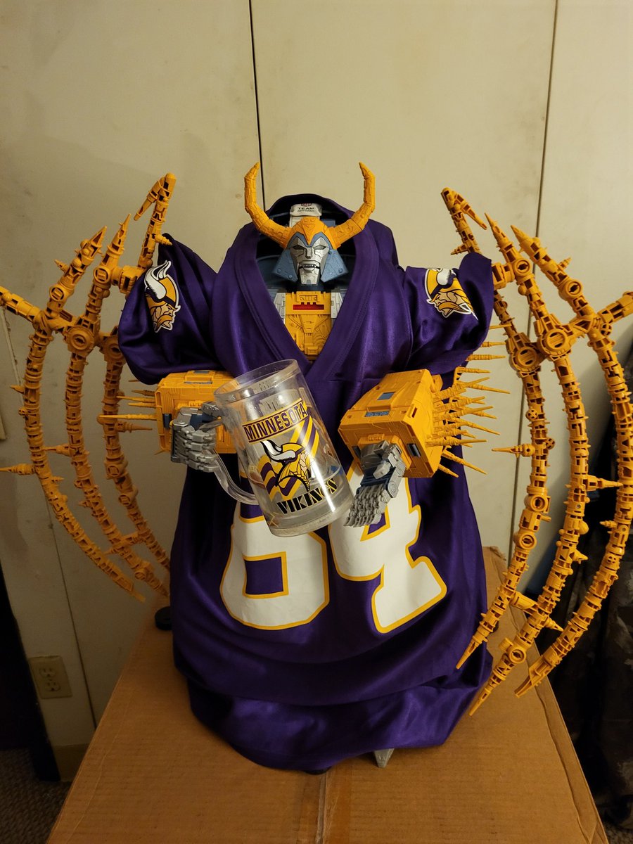 Jake_Lilya's tweet image. Just another picture of my Transformers Haslab Unicron with a Vikings jersey on and holding a Vikings mug.