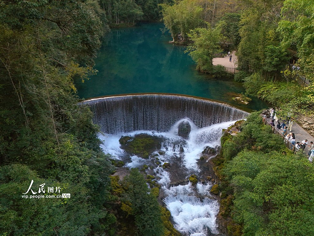 PDChinaLife's tweet photo. The Xiaoqikong scenic spot featuring an ancient stone bridge with seven arches allures visitors to impressive vistas including rushing waterfalls and crystal clear waters in Libo County, southwest China's Guizhou Province. #TravelInChina https://t.co/4dbZlSzk7I