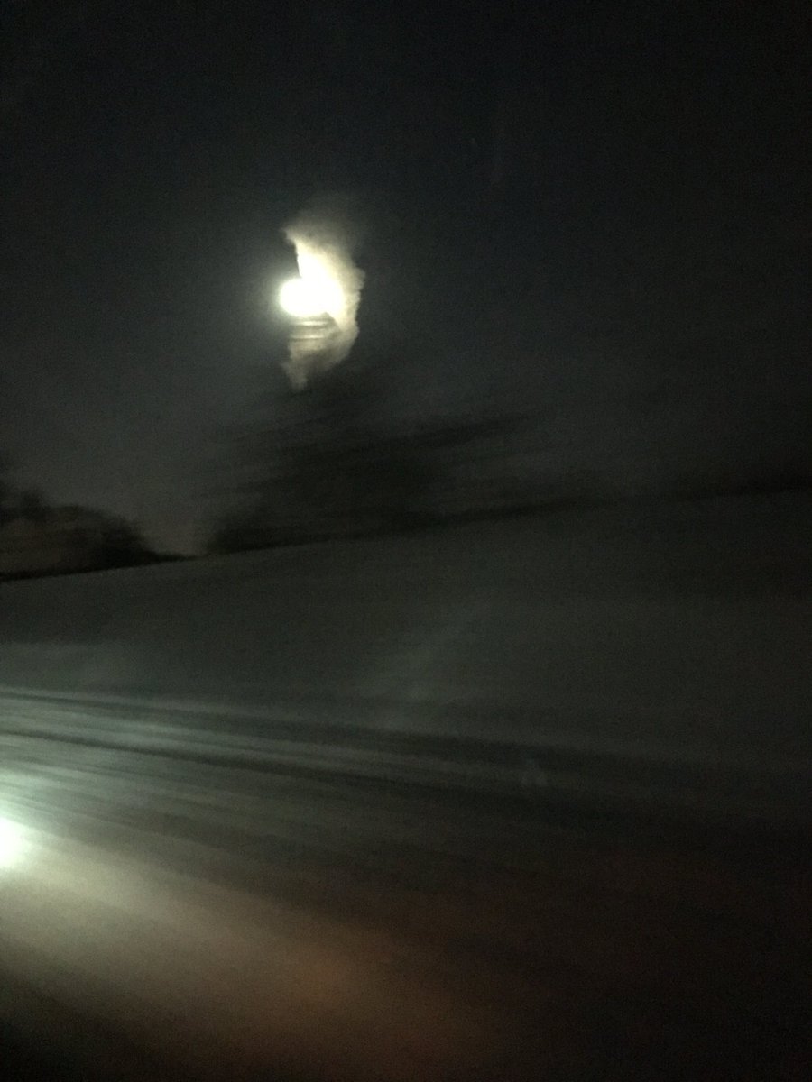 I barely got this picture of a cloud wrapped around the moon in a swirl. You can barely see it. I quick told my sister to stop the car but she thought she would go up a bit &amp; pull over. By that time it was gone! It lasted but for a minute.