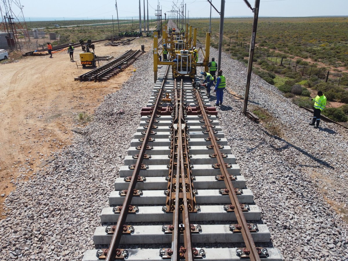 RailwaysAfrica's tweet photo. #picoftheday

Loop 3 - 143km from Saldhana a 1:20 turnout is being installed. This 1:20 turnout, manufactured by voestalpine Railway Systems - VAE SA, is first assembled next to the track. Once the previous turnout has been removed a GEISMAR PEMLEM is used to place the turnout, consisting of two panels, in-track. New ballast, tamping and welding of rail follows.

#transnet #rail #railway #railwaymaintenance #track #railwaytrack