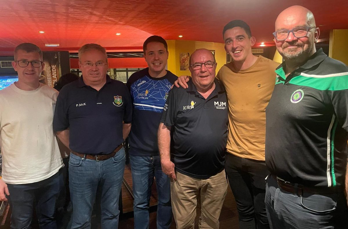 WarrenpointGAA's tweet photo. Paul, Shane &amp; Daniel made the journey to our twinning club Lugdunum for Saturday’s Pan-European Gaelic Football finals and were greeted by friend &amp; Lugdunum Chairman Eoin Campbell. They are joined by Colin Bell, KBRT, worn on the jerseys of the Lugdunum team this weekend. https://t.co/FzMB5ceGTT