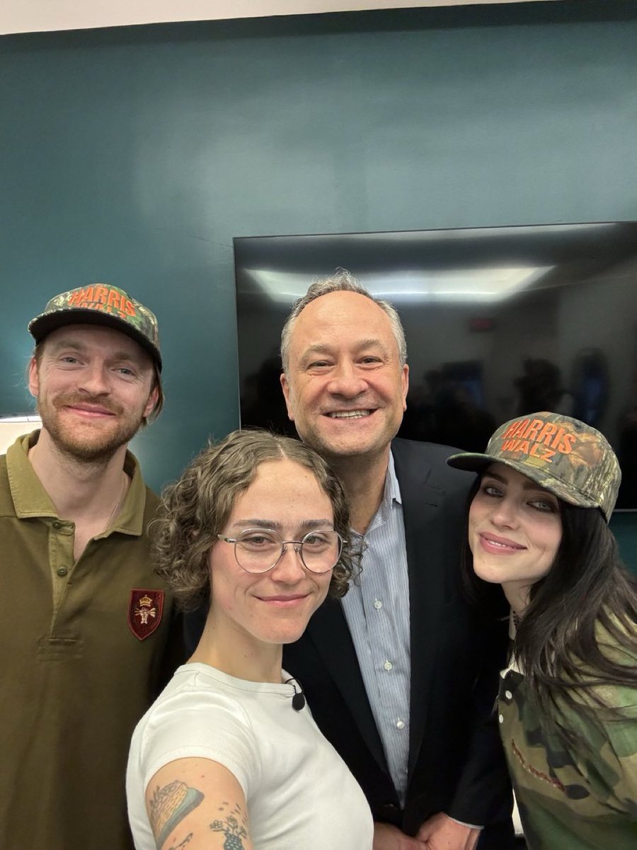 KnowaDeBaraso's tweet photo. THIS IS HUGE: Billie and Finneas Eilish wearing the Harris Walz camo hat alongside Second Gentleman Doug Emhoff! https://t.co/SMkdyacXad