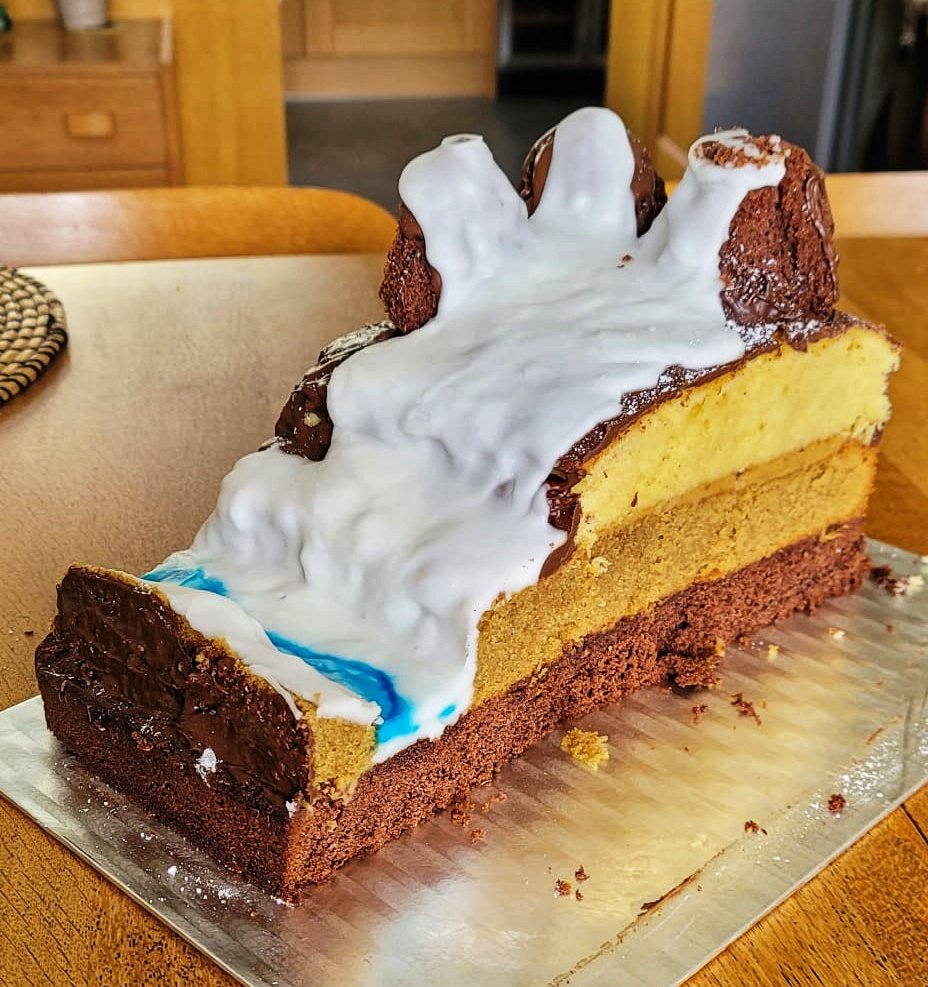 Can I show you something truly magnificent? It's a birthday cake (made by a very talented family member) with the theme of GLACIAL GEOLOGY. Includes mountains, a glacier, a terminal moraine, a river, and stratification.