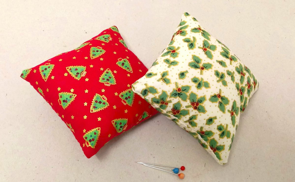 A lovely set of two Christmas pin cushions. One in red with christmas trees, one in white with holly, Free delivery.  #handmadegift #christmaspincushion #sewingaccessory #pincushions #christmasgift etsy.com/uk/listing/162…