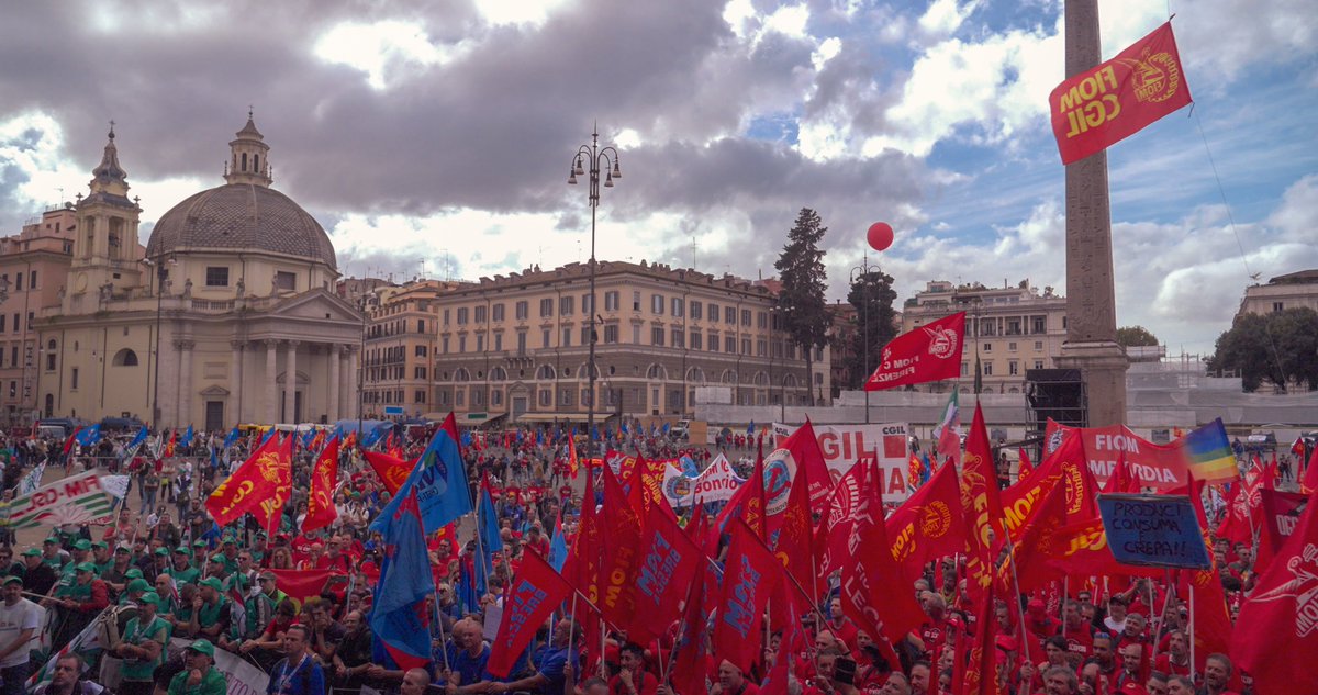 UAW's tweet photo. UAW Region 4 Director Brandon Campbell and UAW Local 1268 President Matt Frantzen joined tens of thousands automotive workers as they marched through the streets of Rome on Friday to demand better work conditions at Stellantis, protest the company’s significant production cuts, and call out its baldfaced corporate greed.