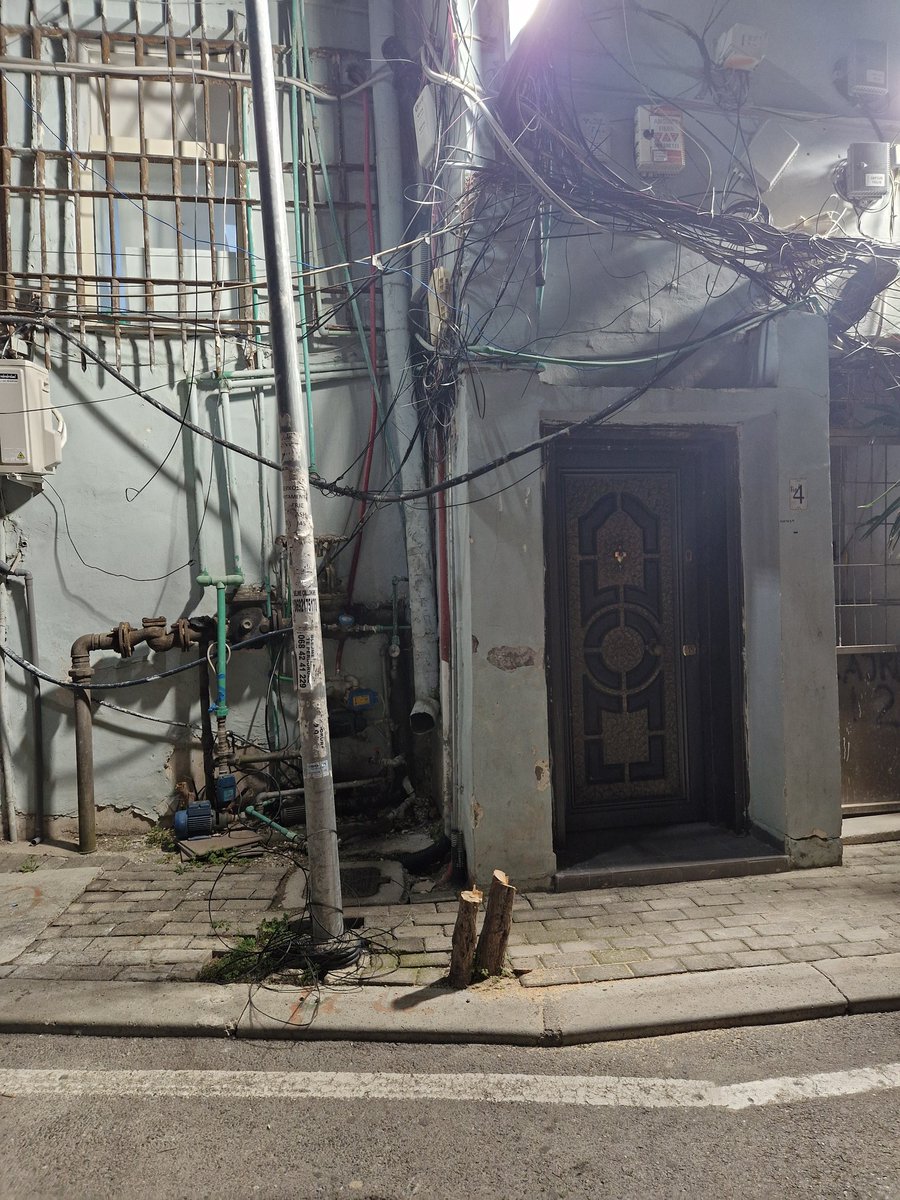 Daylight crime at the entrance of my appartment, centre of Tirana.  Someone cut this little nice tree. Difficult/impossible to understand the reason why. Local and centre government very busy with more important problems. Looks ugly as it is. Powerless to cope with destruction.
