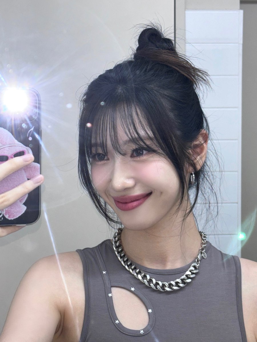 Down for a soft yet bold look. My hair is tied up in a simple bun but I left some loose strands and bangs framing my face to add softness. I kept my makeup natural with a hint of blush and pink lips for a fresh look, perfect for a spontaneous mirror selfie session.
