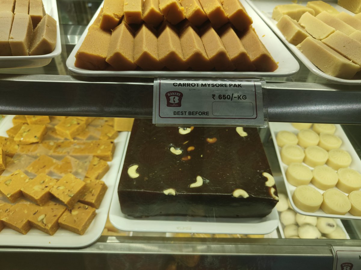 ndcnn's tweet image. Carrot Mysore Pak now.  Hmm. Not tried. Horlicks Mysore Pak I have been buying for some time as there are fans in the family.  This is at Best Bakers Kochi. #sweets #fusion #experiments