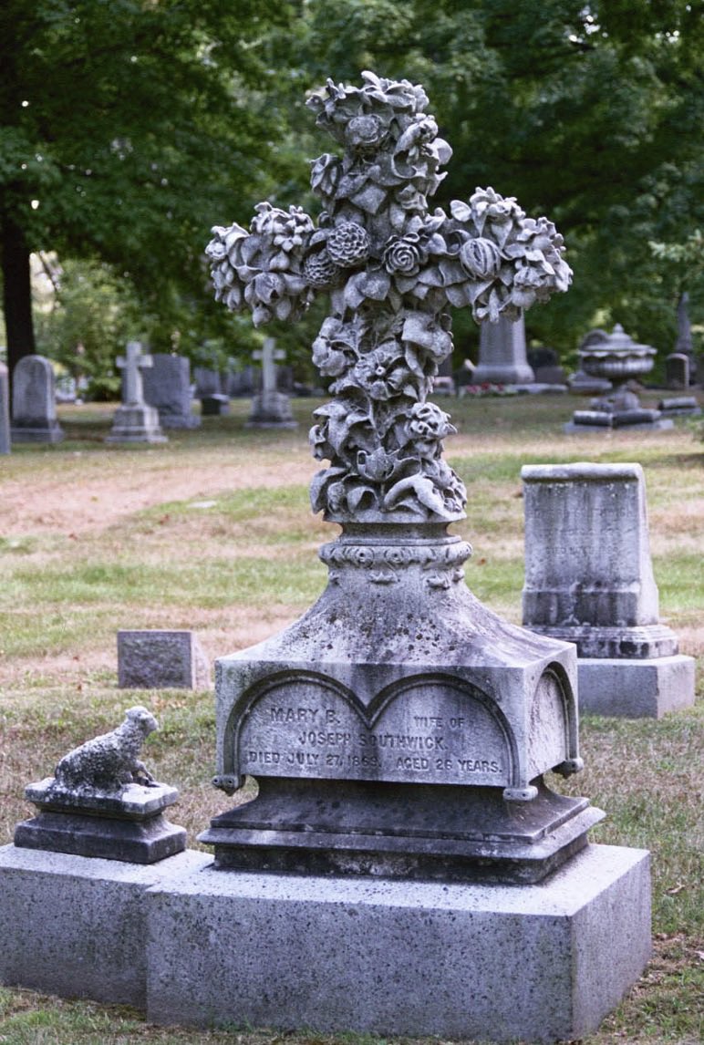 #31DaysOfGraves  Day 22: Flower. A multitude of wilting blooms—at least 12 different varieties—and a tour de force of the sculptor’s hand: the language of flowers for Mary Southwick, who died only days after her newborn, Joseph Jr, the lamb next to her. Forest Hills Cem, Boston.