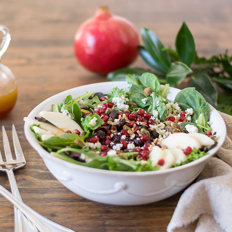This simple green #ChristmasSalad is made #festive with the addition of seasonal produce like fresh, juicy #pears, bright red #pomegranate seeds, crunchy pistachios, and sunflower seeds, salty and earthy #gorgonzola cheese, and chewy dried #cranberries. bit.ly/3FxAeNZ