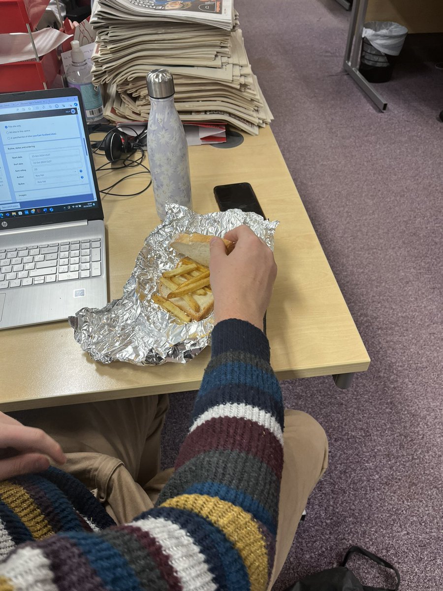 Subchimp's tweet photo. This is teamwork right here. @RoryFell lifted the wrong package from his fridge this morning, and found his sandwiches were nothing more than empty buttered bread. Gutting! Who even wraps that in foil? @goodall_chloe to the rescue with spare Five Guys bag fries for a chip butty. https://t.co/ZrwPCqATvn