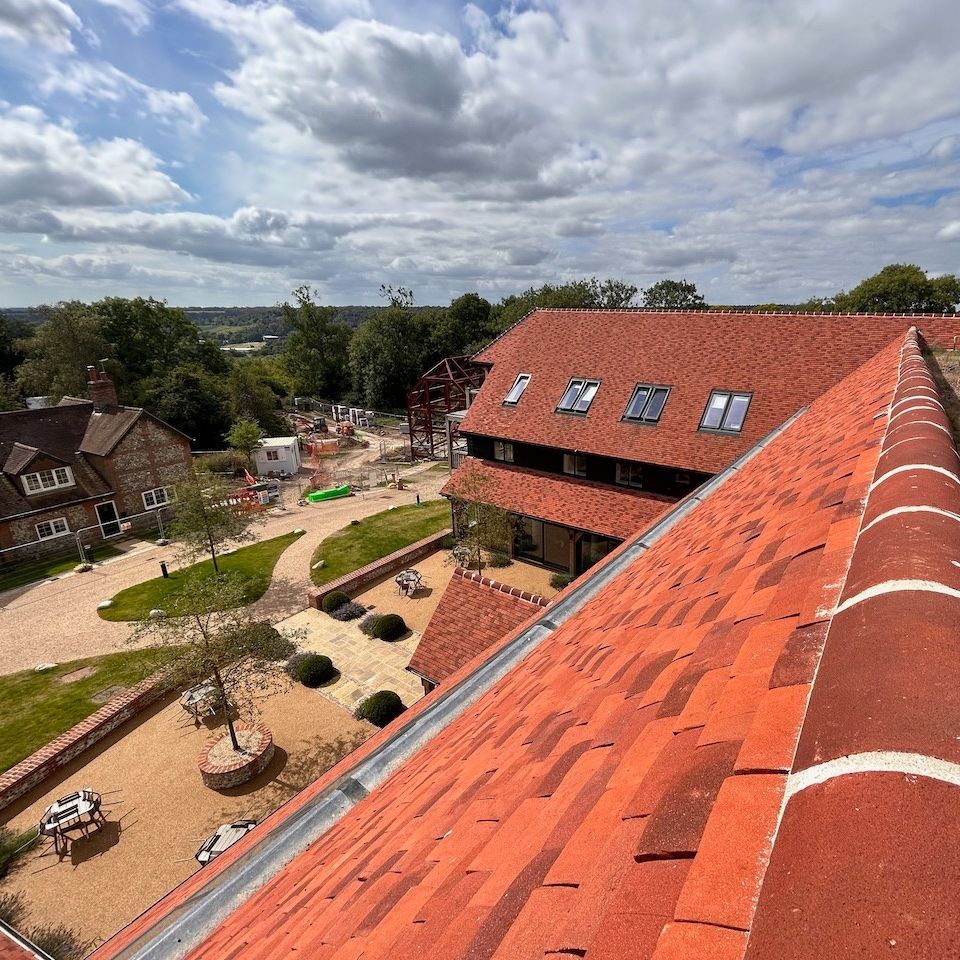 The project included an oak-framed veranda bolted to a steel frame in a large courtyard, along with an oak porch set on staddle stones at the entrance. Next stage involved preassembled oak-framed balconies with balustrades, lifted into place and fitted to steel flitch plates.