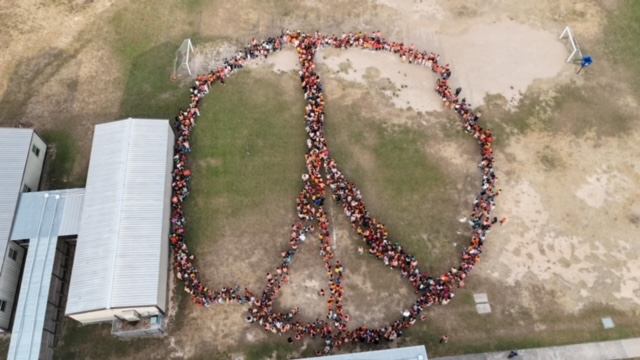 On Unity Day, this past week, Wilson Elementary took a stunning school-wide photo in the shape of a peace sign to celebrate Bullying Prevention Awareness Month! Nearly 1,100 students and staff joined. This year's theme: "Peace, Love, and Wilson Wolfpack."