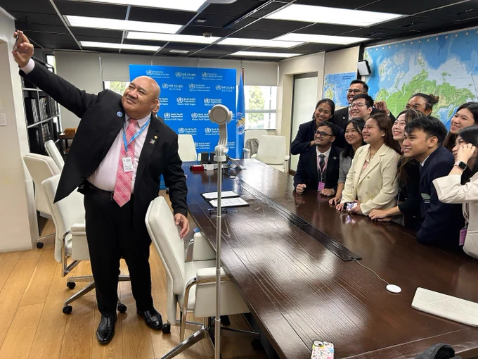 WHO Regional Director Doctor Saia Ma'u Piukala takes a selfie with representatives of the International Federation of Medical Students Association and the International Pharmaceutical Students' Federation 