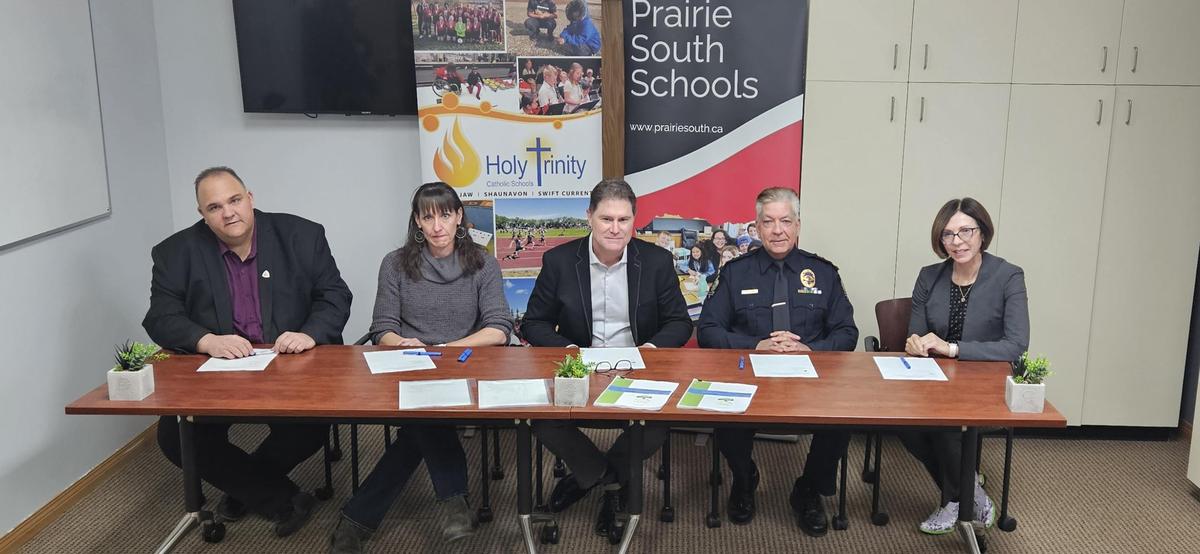 Renewed Community Threat Assessment and Support Protocol - Holy Trinity Catholic School Division and Prairie South School Division, along with their Community Protocol Partners, sign a renewed Community Threat Assessment and Support scho.ca/n850645
