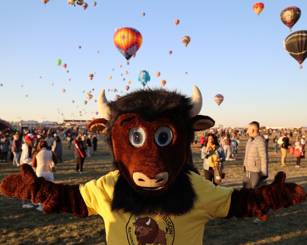 NatParkTrust's tweet photo. Where has #BuddyBison been this #Fall?🦬

⭐Buddy soared to new heights at @PetroglyphNPS during the Albuquerque International Balloon Festival!🎈

⭐He stopped by @SPARNHS at the Big E State Fair and a "Read with a Ranger" event at Forest Park Zoo. 

Where will Buddy be next? 🤔 https://t.co/EeOIYdgtyO