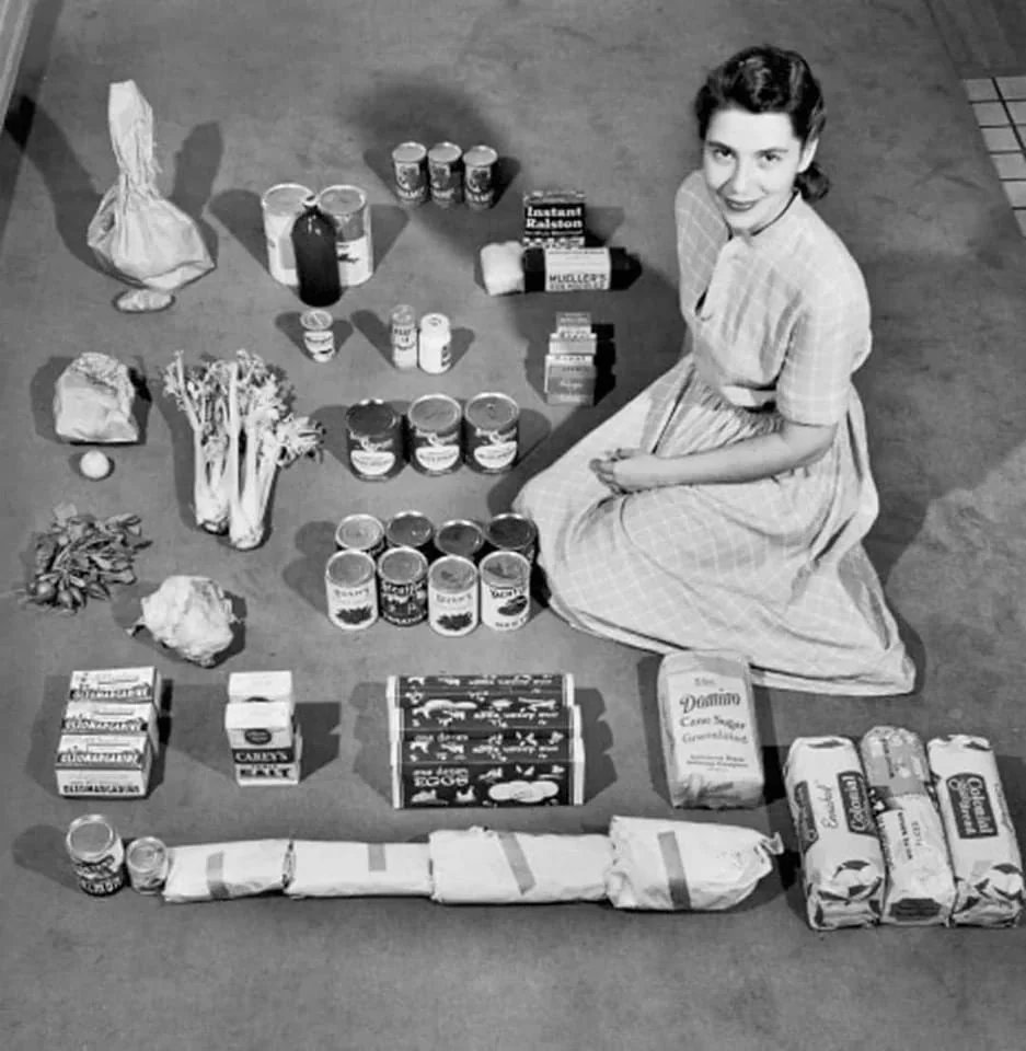 3. Housewife poses with a weeks’ worth of groceries in 1947. She spent a total of $12.50 (not including milk) to buy her groceries. On this budget, she is able to feed herself, her husband, her four-year-old twins &amp; their cat.