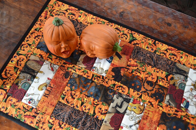 “Dia de los Muertos” Table Runner  etsy.me/4dZiLwy via <a href="/Etsy/">Etsy</a> #halloween #tablerunner #diadelosmuertos #dayofthedead #quilt #sugarskull #skull #spiderweb #roses #rip #orange #black #gray #white #skeleton #guitar #jackolantern #pumpin #green #red #blue