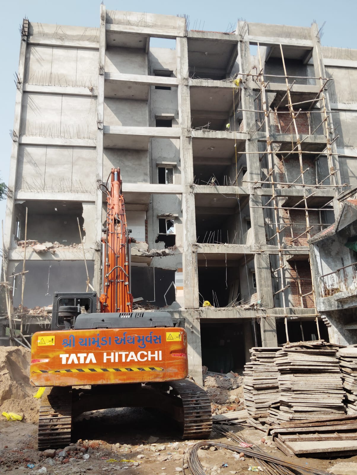 AMC bulldozes under-construction illegal Neha Flats in Juhapura, Sarkhej